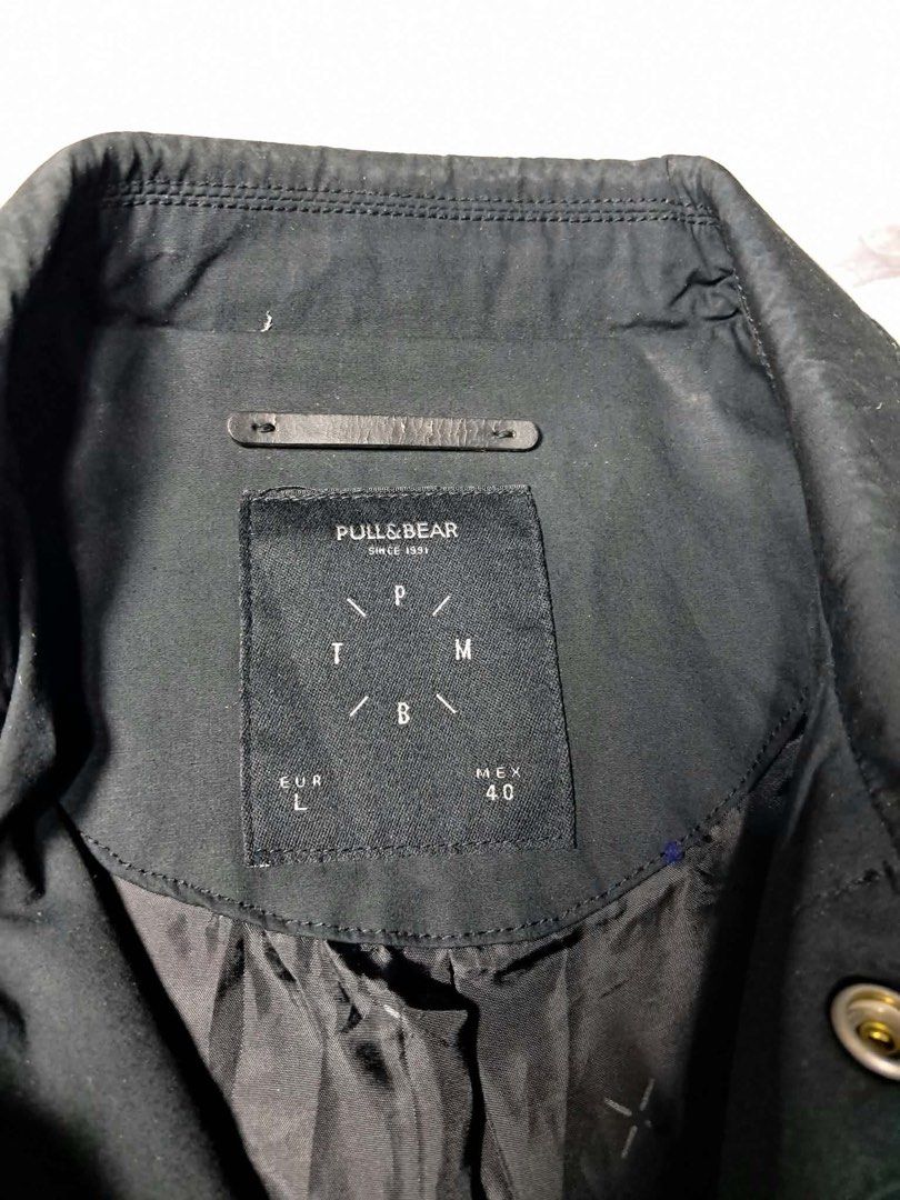 Pull and Bear Black Coach Jacket Size M (Category: Coats, Jackets and Outerwear) located in Baguio. Submitted by padisellsz (Listing ID 1465459087, Image 3). Description: - Brand: Pull & Bear - Very good condition - No issues - Style: Black longline coach jacket - Size: Medium - Measurements: 22" width x 33" length x 27" sleeve - Material: 100% cotton outer shell - Features: Button-up front, classic collar, ribbed cuffs, and adjustable drawstring