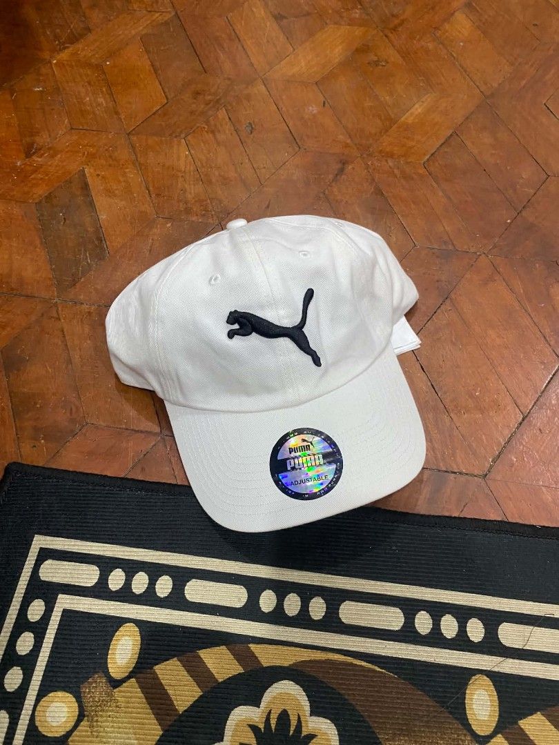 Puma White Cap with Black Logo Adjustable (Category: Caps & Hats) located in Pasig City. Submitted by paulclzdo (Listing ID 1465455692, Image 1). Description: - Brand: Puma - Color: Clean White - Logo: Classic black jumping cat embroidery on front - Authenticity: Original holographic sticker on the brim - Fit: Adjustable strap in the back for custom sizing - Condition: Brand new / Excellent, clean fabric throughout.