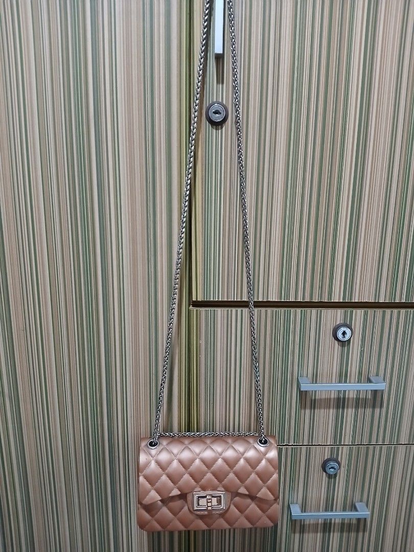 Quilted Brown Shoulder Bag with Chain Strap (Category: Cross-body Bags) located in Taguig. Submitted by demsclosetph (Listing ID 1465432918, Image 3). Description: - Color & Finish: Glossy brown quilted design - Hardware: Silver-tone chain strap and grommets - Closure: Secure front flap with rectangular turn-lock - Structure: Flat bottom panel to hold its shape - Size: Compact, perfect for daily essentials - Style: Versatile classic that pairs ea