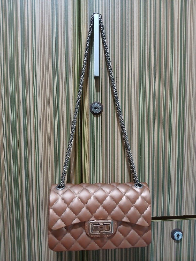 Quilted Brown Shoulder Bag with Chain Strap (Category: Cross-body Bags) located in Taguig. Submitted by demsclosetph (Listing ID 1465432918, Image 1). Description: - Color & Finish: Glossy brown quilted design - Hardware: Silver-tone chain strap and grommets - Closure: Secure front flap with rectangular turn-lock - Structure: Flat bottom panel to hold its shape - Size: Compact, perfect for daily essentials - Style: Versatile classic that pairs ea
