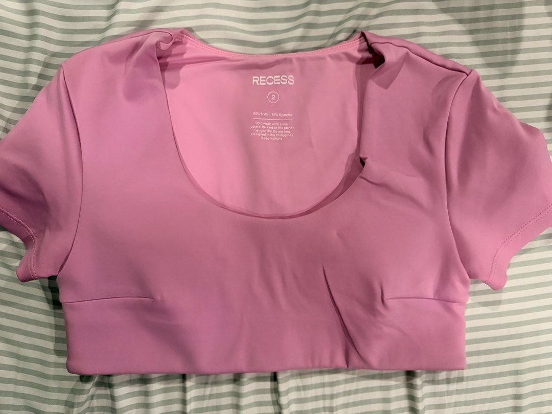 Recess Pink Athletic Crop Top Size 2 (Category: Activewear) located in Marikina City. Submitted by teacher.maria (Listing ID 1465390975, Image 1). Description: - Brand: Recess - Color: Pink - Style: Athletic crop top with short sleeves and scoop neckline - Size: Tagged size 2 - Material: 85% nylon, 15% spandex (stretchable and comfortable) - Origin: Designed in the Philippines, made in China - Care: Cold wash (instructions printed inside collar).