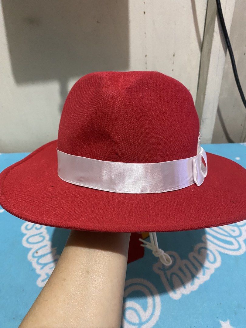 Red Fedora Hat with White Ribbon and Chin Strap (Category: Hats & Beanies) located in Manila. Submitted by resi.diaz (Listing ID 1465431504, Image 3). Description: - Color: Bright red - Features: White satin ribbon with bow around the crown - Brim: Wide brim style - Security: Adjustable white cord chin strap with a toggle - Condition: Clean fabric - Best for: Outdoor wear or costume use.