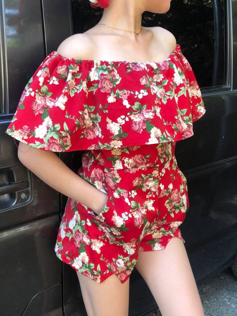Red Floral Off-Shoulder Romper (Category: Rompers) located in Manila. Submitted by vintagefindssay (Listing ID 1465526913, Image 3). Description: - Bright red romper with pink and white roses - Off-shoulder neckline with a chic ruffled overlay - Functional deep pockets on both sides - Flattering high-waisted fit with built-in shorts - Lightweight, breathable fabric ideal for warm weather - Condition: Worn only once for a quick photo shoot, no fla