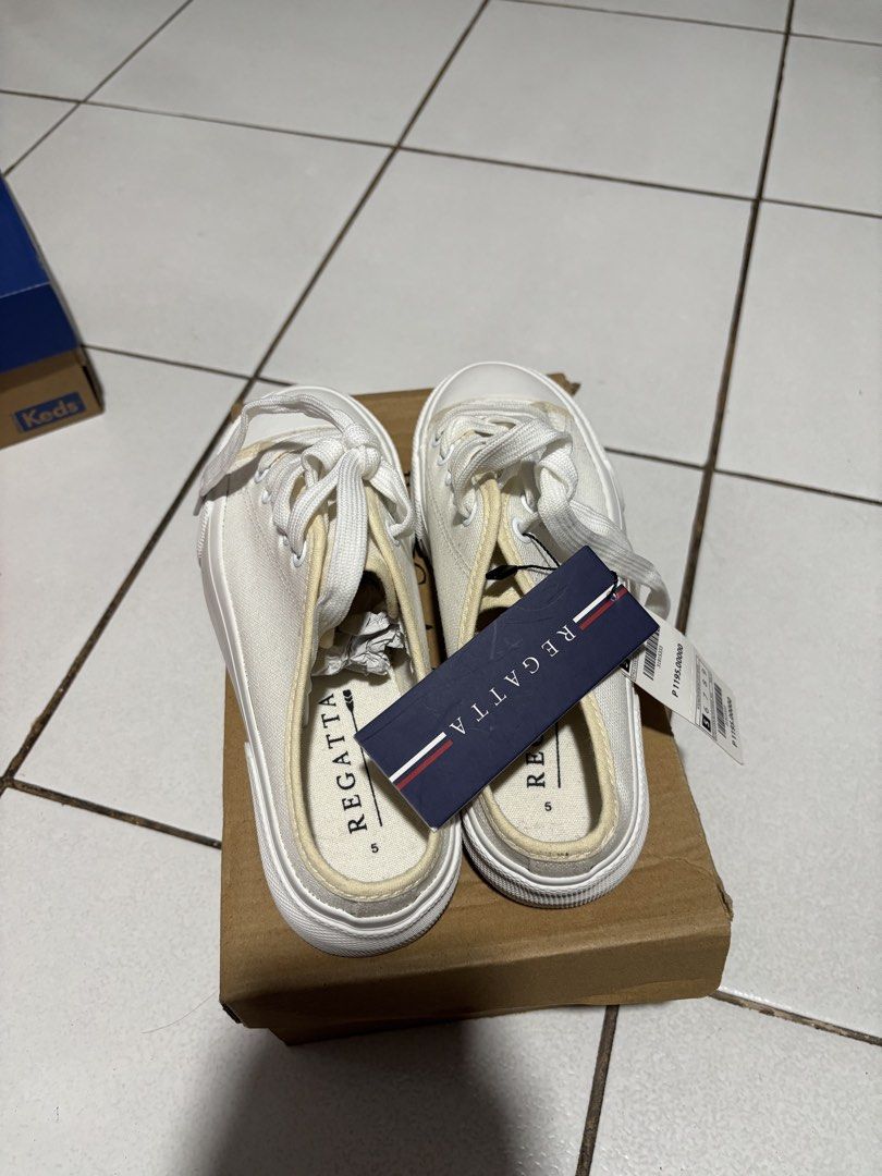 Regatta White Canvas Slip-on Sneakers (Category: Sneakers) located in Calamba. Submitted by rafabariso (Listing ID 1465496483, Image 1). Description: - Brand: Regatta - Style: Low-back mule canvas slip-ons with front laces - Size: 5 - Condition: Brand new with tags (BNWT), never worn - Color: Clean white - Features: Versatile everyday footwear that matches any outfit - Reason for selling: Decluttering extra pairs.