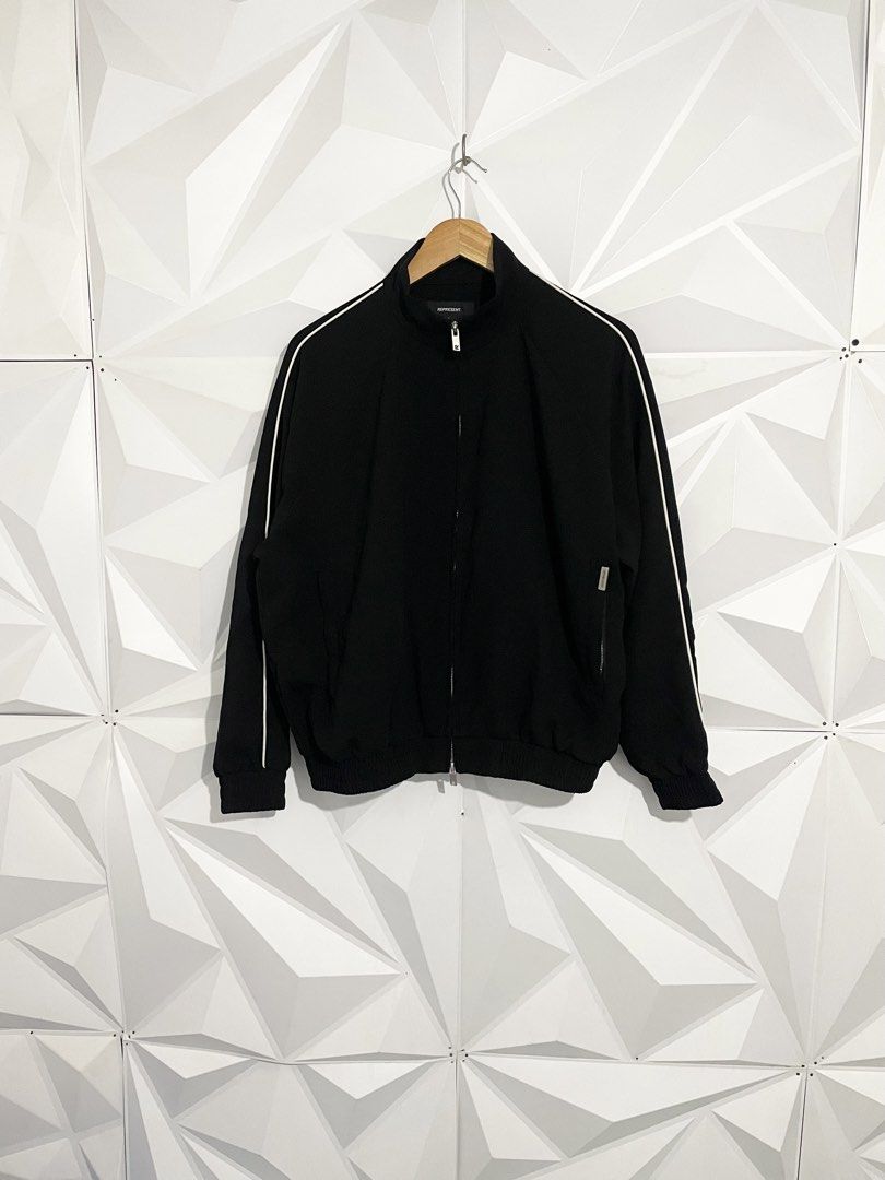 Represent Black Track Jacket with White Piping Size XL (Category: Coats, Jackets and Outerwear) located in Cabuyao City. Submitted by ParadisethriftedPh (Listing ID 1465463608, Image 1). Description: Cr: 9.8/10 Dimensions W: 24.5 L: 25 - Color: Classic black with white piping on sleeves - Size: XL on tag - Material: 100% premium cotton - Features: Full zip closure with custom 'R' hardware pulls, stand collar, ribbed cuffs and hem - Pockets: Conve