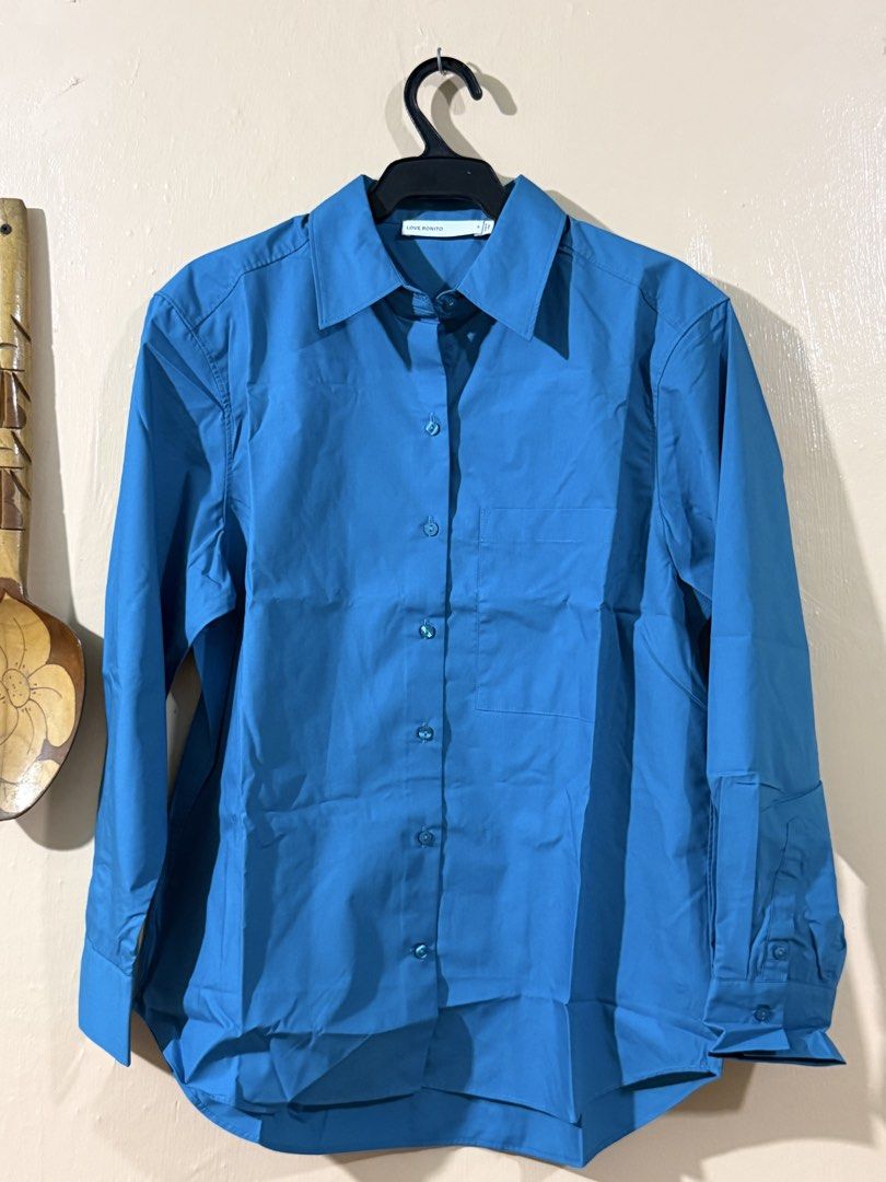 RuchedReady® Riley Relaxed Cotton Button Down Shirt (Category: Blouses) located in Manila. Submitted by castillopa17379 (Listing ID 1465515126, Image 1). Description: - Brand: Love Bonito - Style/Color: Teal - Size: S - Features: Right chest pocket, soft cotton and polyester blend - Condition: Brand new, still sealed in original plastic packaging with silica gel packet - Style Number: 11A5091067.