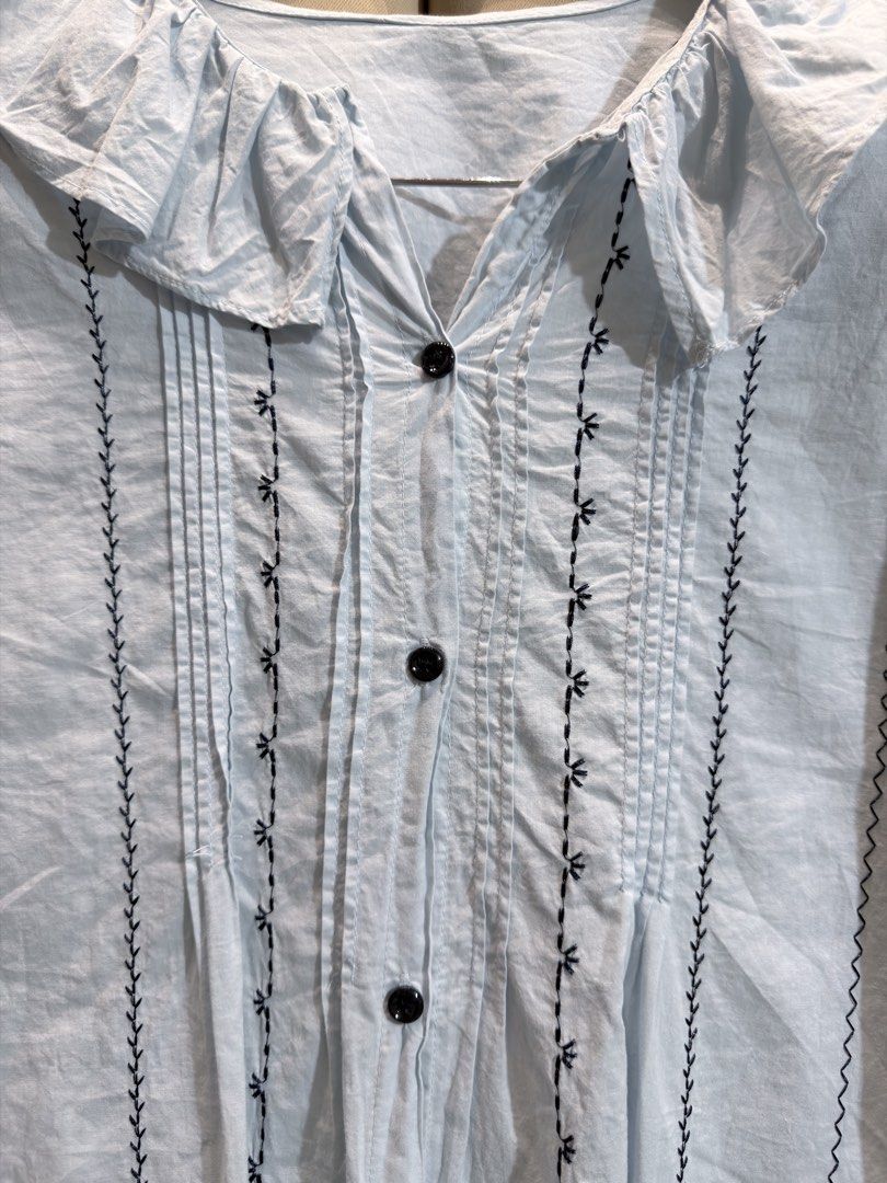 Ruffle Collar Pintuck Blouse (Category: Blouses) located in Manila. Submitted by glamstylemnl (Listing ID 1465457467, Image 3). Description: ♡ SIZE: L ♡ BUST: 41 ♡ Swipe left to see the actual color & details ♡ button-up / black embroidered vertical trim / ruffle collar ♡ HQ • 10/10 ♡ Ready to wear 👚.