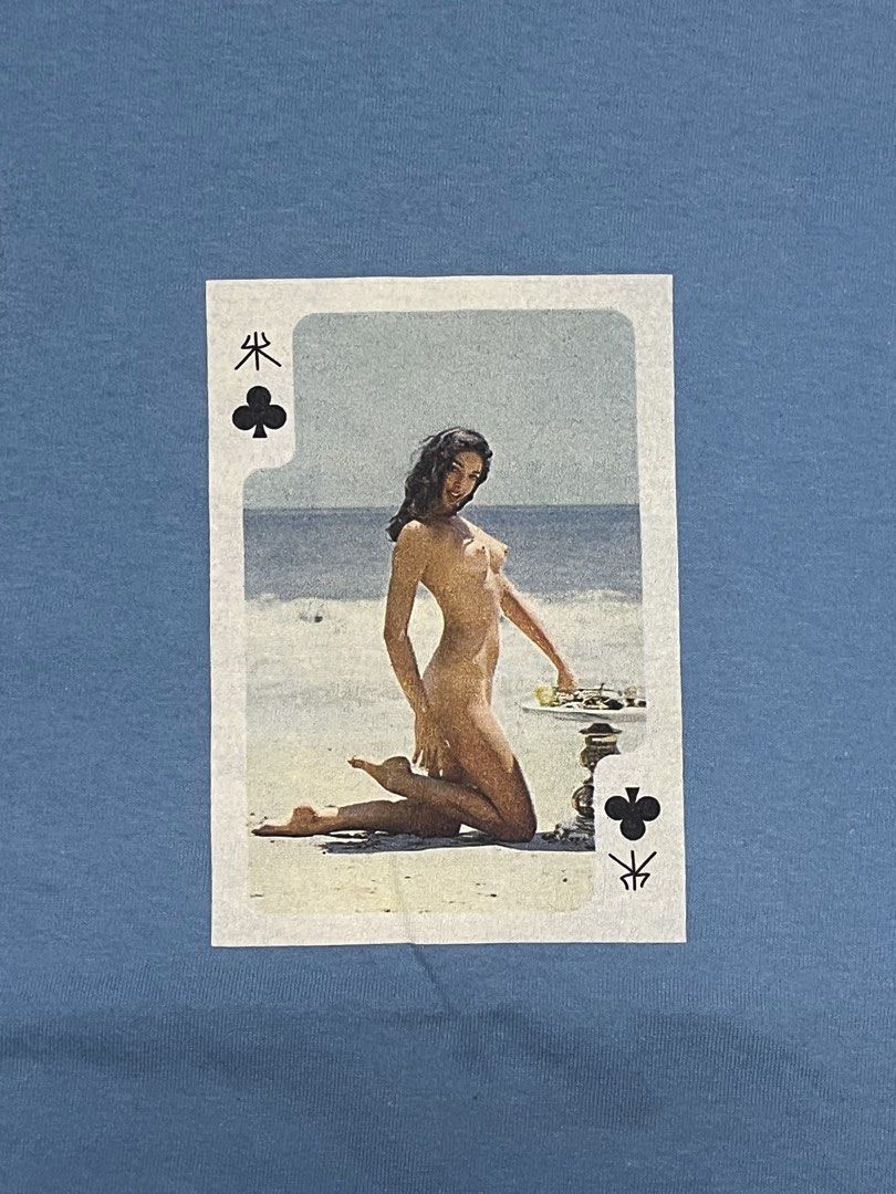 S3xy card graphic size M •19.5x29 (Category: Tshirts & Polo Shirts ) located in Cebu City. Submitted by guttathreads (Listing ID 1465454313, Image 2). Description: - Color: Light blue - Size: M (printed inside collar) - Design: Center chest playing card graphic with a beach scene - Fit: Standard fit with short sleeves - Condition: Clean fabric all over - Style: Versatile casual streetwear, pairs well with jeans or shorts.