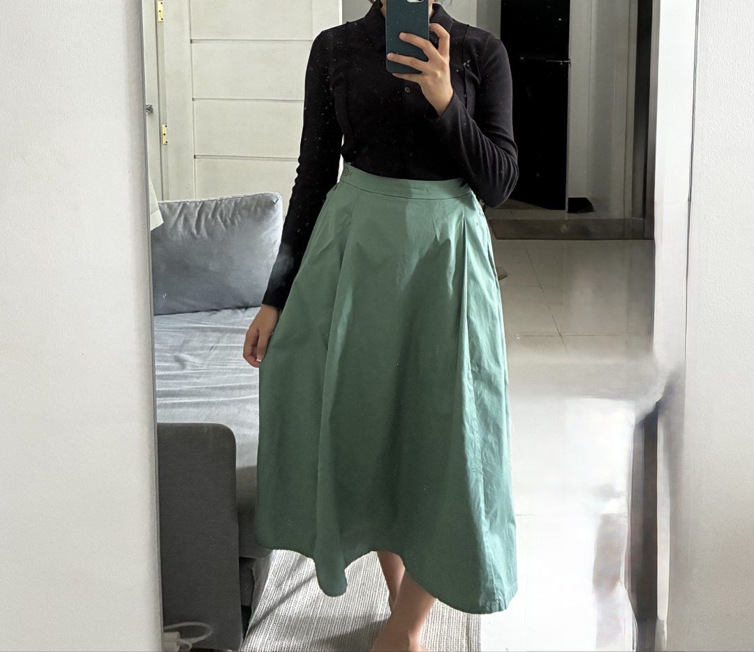 Muji Pleated Skirt (Category: Skirts) located in Dasmarinas. Submitted by fermosaclothing (Listing ID 1465414825, Image 2). Description: - Color: Sage green (solid) - Length: Midi (falls right below the knee) - Fit: High-waisted with partially elasticized back waistband - Closure: Side zipper with a single button - Features: Box pleats all around and deep pockets on both sides - Fabric: Lightweight and comfortable - Styling tip: Pairs well with b