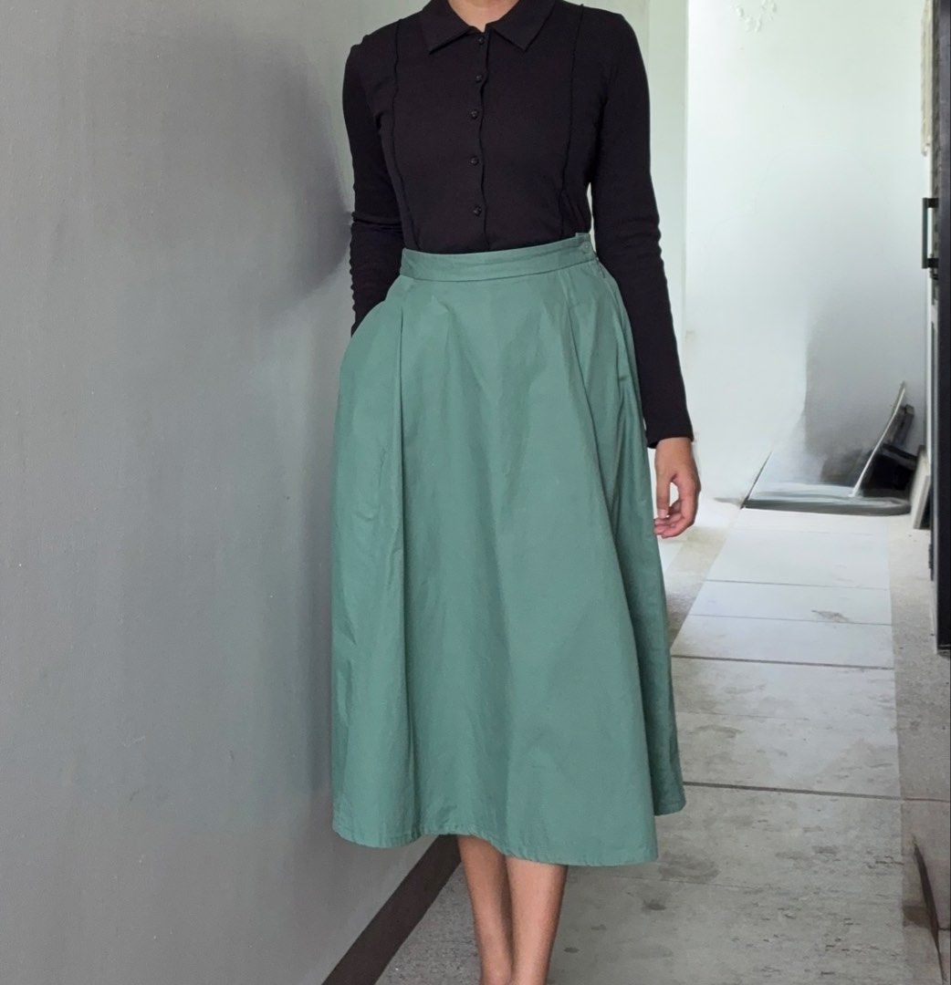 Muji Pleated Skirt (Category: Skirts) located in Dasmarinas. Submitted by fermosaclothing (Listing ID 1465414825, Image 1). Description: - Color: Sage green (solid) - Length: Midi (falls right below the knee) - Fit: High-waisted with partially elasticized back waistband - Closure: Side zipper with a single button - Features: Box pleats all around and deep pockets on both sides - Fabric: Lightweight and comfortable - Styling tip: Pairs well with b