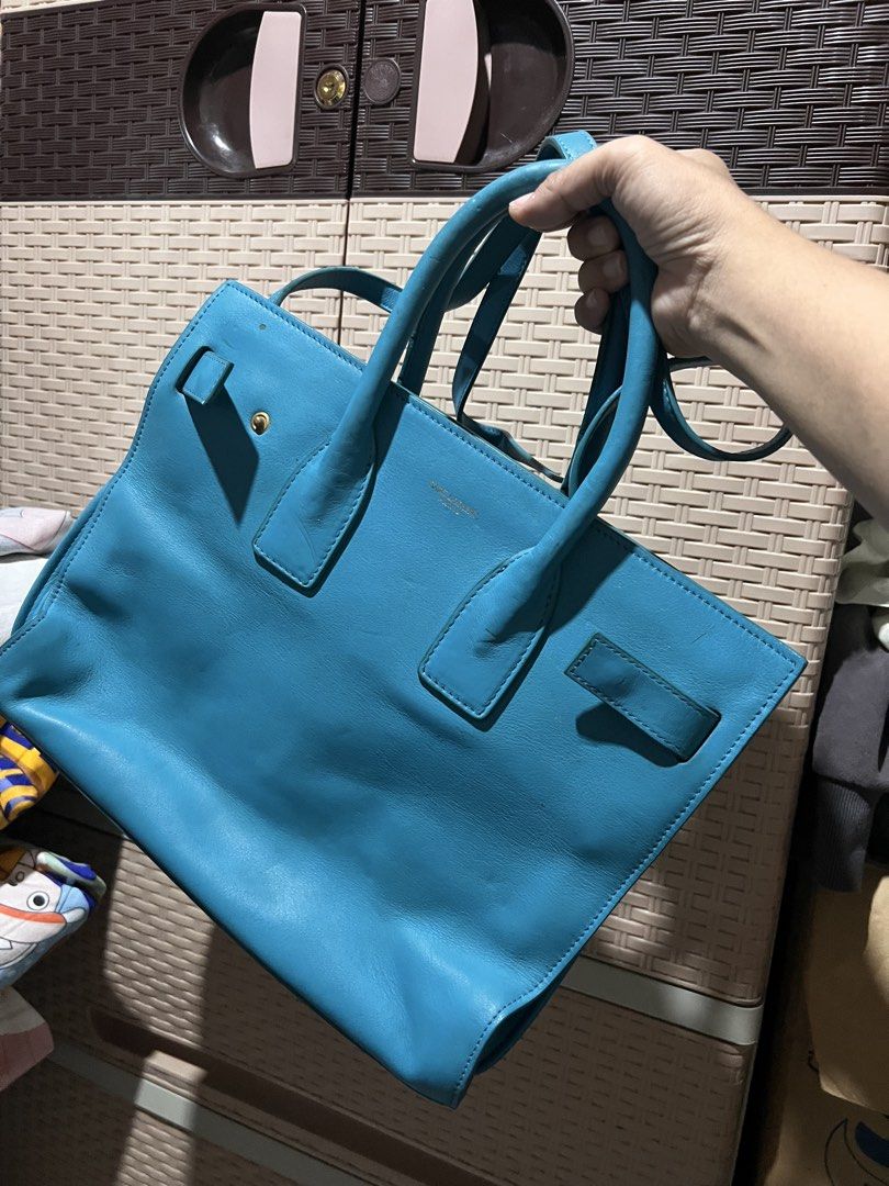 Saint Laurent Blue Leather Handbag (Category: Luxury Bags & Wallets) located in Quezon City. Submitted by rizza14ortiz (Listing ID 1465458068, Image 2). Description: handbag in a stunning bright blue - Features double top handles and a convenient detachable crossbody strap - Luxurious gold-tone hardware and secure zipper closures - Multiple interior compartments with handy zipped pockets - Condition: Noticeable surface creases and minor scuffs fr