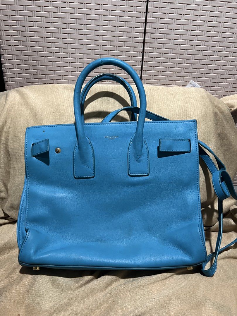 Saint Laurent Blue Leather Tote Bag (Category: Tote Bags) located in Manila. Submitted by mightylion-ce6ea7 (Listing ID 1465463220, Image 1). Description: - Brand: Saint Laurent - Color: Bright blue - Material: Premium leather with gold-tone hardware - Straps: Double top handles and adjustable shoulder strap - Interior: Spacious with multiple zipped compartments and YSL leather tag - Condition: Minor wear on corners and surface from normal use - 