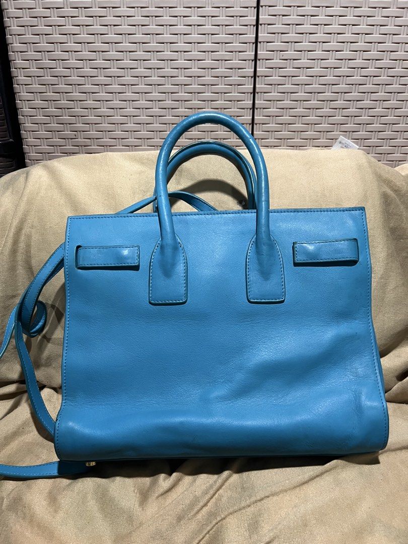 Saint Laurent Blue Leather Tote Bag (Category: Tote Bags) located in Manila. Submitted by mightylion-ce6ea7 (Listing ID 1465463220, Image 3). Description: - Brand: Saint Laurent - Color: Bright blue - Material: Premium leather with gold-tone hardware - Straps: Double top handles and adjustable shoulder strap - Interior: Spacious with multiple zipped compartments and YSL leather tag - Condition: Minor wear on corners and surface from normal use - 