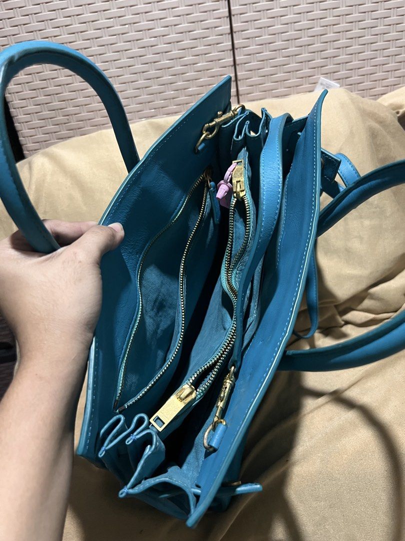 Saint Laurent Blue Leather Tote Bag (Category: Tote Bags) located in Manila. Submitted by mightylion-ce6ea7 (Listing ID 1465463220, Image 2). Description: - Brand: Saint Laurent - Color: Bright blue - Material: Premium leather with gold-tone hardware - Straps: Double top handles and adjustable shoulder strap - Interior: Spacious with multiple zipped compartments and YSL leather tag - Condition: Minor wear on corners and surface from normal use - 
