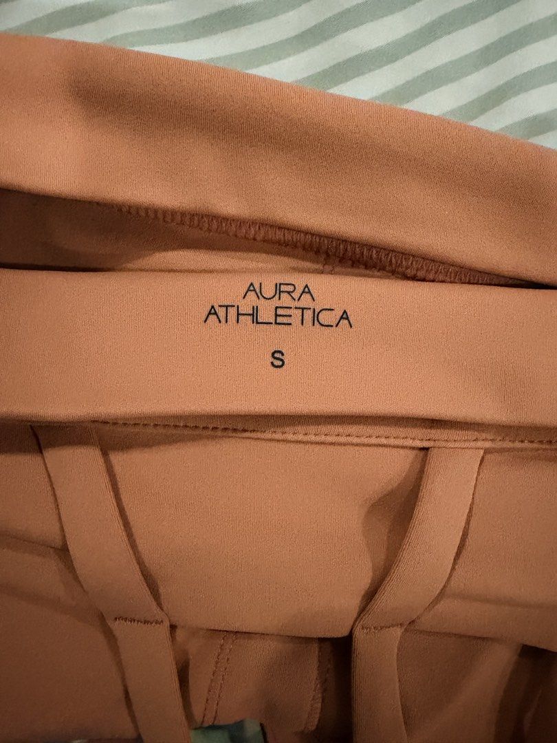 Salmon Sports Bra (Category: Activewear) located in Marikina City. Submitted by teacher.maria (Listing ID 1465391055, Image 3). Description: - Brand: Aura Athletica - Color: Warm orange - Size: Small - Design: Strappy cross-back for great support - Features: Built-in padding, soft and stretchy fabric - Condition: Clean, tags removed.