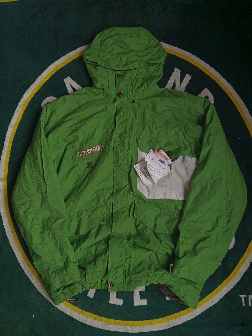 Salomon Green Outdoor Jacket (Category: Coats, Jackets and Outerwear) located in Las Pinas. Submitted by allhandpick (Listing ID 1465398755, Image 1). Description: - Brand: Salomon - Color: Bright green with contrast white panel and brown inner lining - Closure: Full zip and button - Features: Adjustable hood and multiple front pockets - Style: Classic snowboarding / winter jacket - Condition: Great for cold weather trips - Mode of Payment: BPI, 