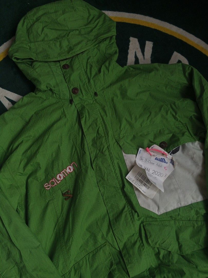 Salomon Green Outdoor Jacket (Category: Coats, Jackets and Outerwear) located in Las Pinas. Submitted by allhandpick (Listing ID 1465398755, Image 2). Description: - Brand: Salomon - Color: Bright green with contrast white panel and brown inner lining - Closure: Full zip and button - Features: Adjustable hood and multiple front pockets - Style: Classic snowboarding / winter jacket - Condition: Great for cold weather trips - Mode of Payment: BPI, 