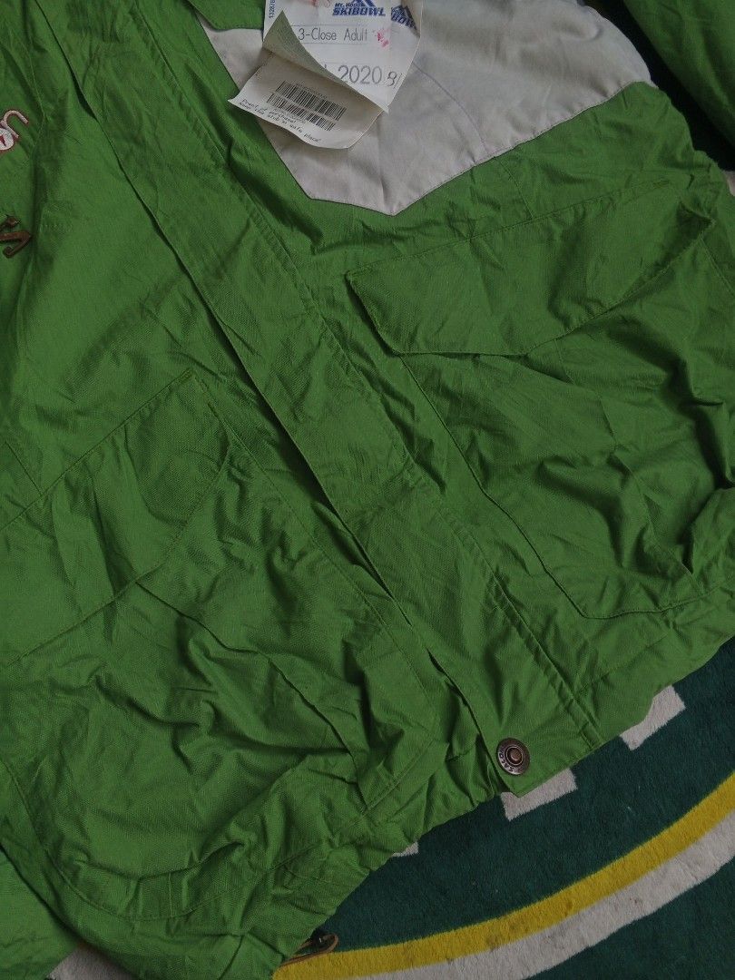 Salomon Green Outdoor Jacket (Category: Coats, Jackets and Outerwear) located in Las Pinas. Submitted by allhandpick (Listing ID 1465398755, Image 3). Description: - Brand: Salomon - Color: Bright green with contrast white panel and brown inner lining - Closure: Full zip and button - Features: Adjustable hood and multiple front pockets - Style: Classic snowboarding / winter jacket - Condition: Great for cold weather trips - Mode of Payment: BPI, 