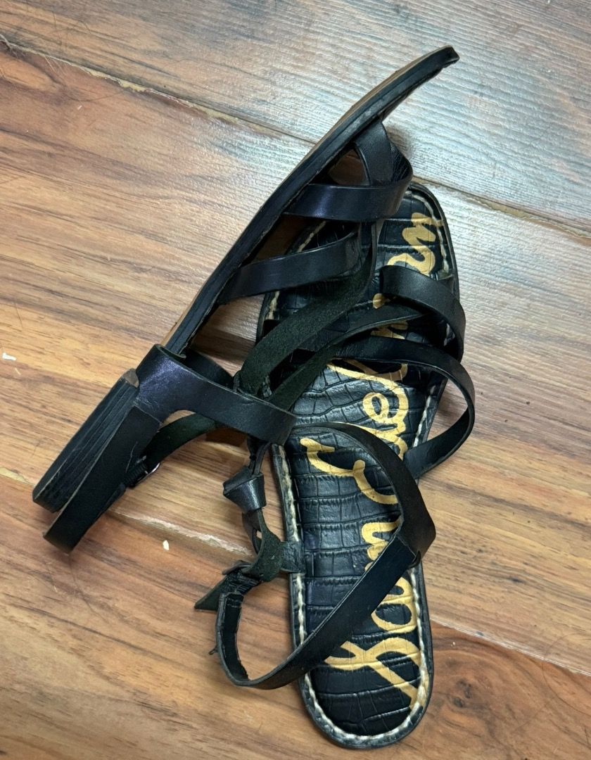 Sam Edelman Black Strappy Sandals (Category: Flats & Sandals) located in Santa Rosa. Submitted by biancamarie0404 (Listing ID 1465433708, Image 2). Description: - Brand: Sam Edelman - Style: Multi-strap black leather sandals with flat soles - Details: Chic textured faux-croc footbeds and gold logo print - Fit: Ankle strap with adjustable buckle closure - Condition: Worn a few times with minor wear on the insoles and outsoles.