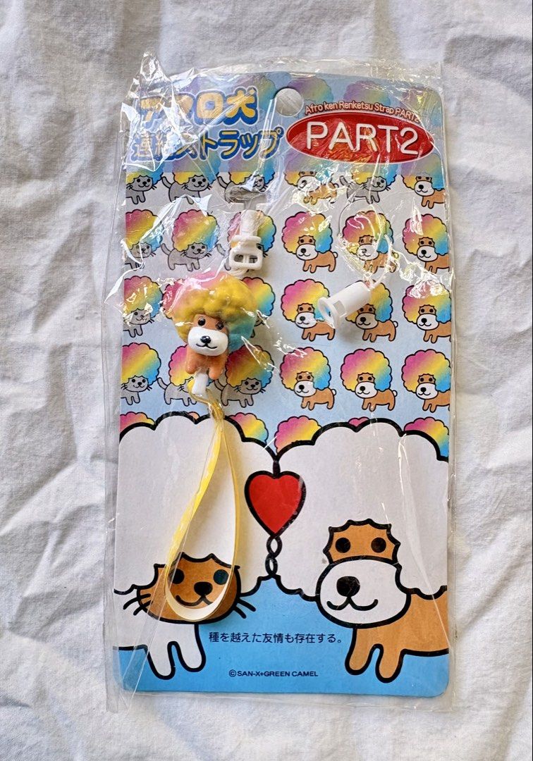 San-X Afro Ken Renketsu Strap Part 2 (Category: Character Goods) located in Tuguegarao City. Submitted by jasminecoll (Listing ID 1465543315, Image 1). Description: - Authentic San-X Afro Ken Renketsu strap - Part 2 - Features a vibrant rainbow afro design with yellow star strap - Rare Green Camel collaboration collector's item - Original backing card packaging intact inside plastic wrap - Brand new and in pristine condition - Perfect for San-X a