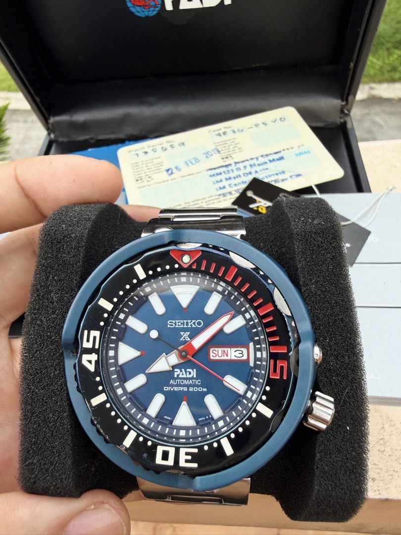 Seiko Prospex PADI Automatic Diver's Watch (Category: Men's Watches) located in Manila. Submitted by evildogchihuahua0701 (Listing ID 1465457300, Image 3). Description: - Brand/Model: Seiko Prospex PADI Automatic Diver's Watch Monster Tuna - Dial: Striking blue textured dial with luminous markers and day-date display at 3 o'clock - Bezel: Iconic red and black rotating bezel - Bracelet: Durable stainless steel bracelet with signed clasp - Inclusio
