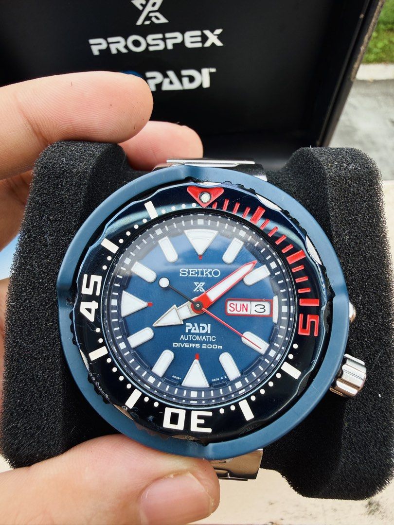 Seiko Prospex PADI Automatic Diver's Watch (Category: Men's Watches) located in Manila. Submitted by evildogchihuahua0701 (Listing ID 1465457300, Image 2). Description: - Brand/Model: Seiko Prospex PADI Automatic Diver's Watch Monster Tuna - Dial: Striking blue textured dial with luminous markers and day-date display at 3 o'clock - Bezel: Iconic red and black rotating bezel - Bracelet: Durable stainless steel bracelet with signed clasp - Inclusio