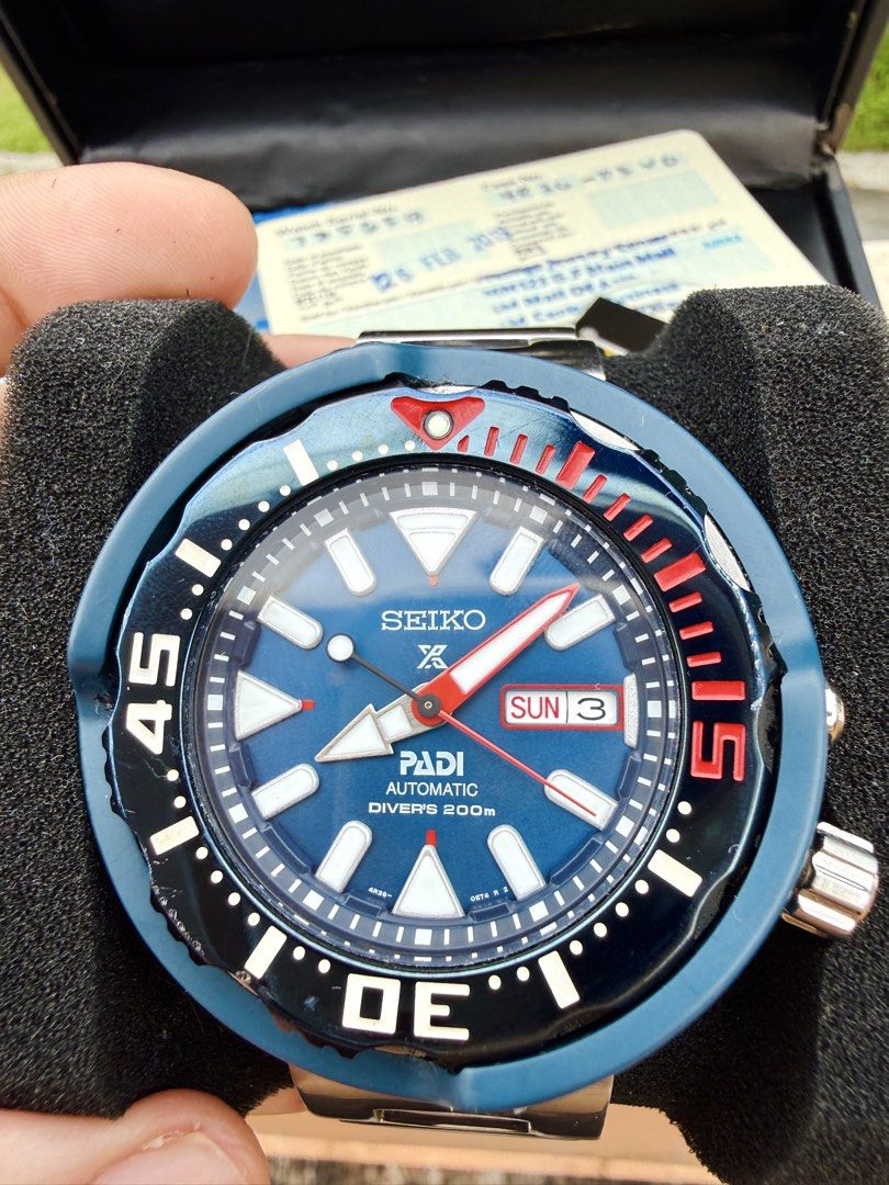 Seiko Prospex PADI Automatic Diver's Watch (Category: Men's Watches) located in Manila. Submitted by evildogchihuahua0701 (Listing ID 1465457300, Image 1). Description: - Brand/Model: Seiko Prospex PADI Automatic Diver's Watch Monster Tuna - Dial: Striking blue textured dial with luminous markers and day-date display at 3 o'clock - Bezel: Iconic red and black rotating bezel - Bracelet: Durable stainless steel bracelet with signed clasp - Inclusio