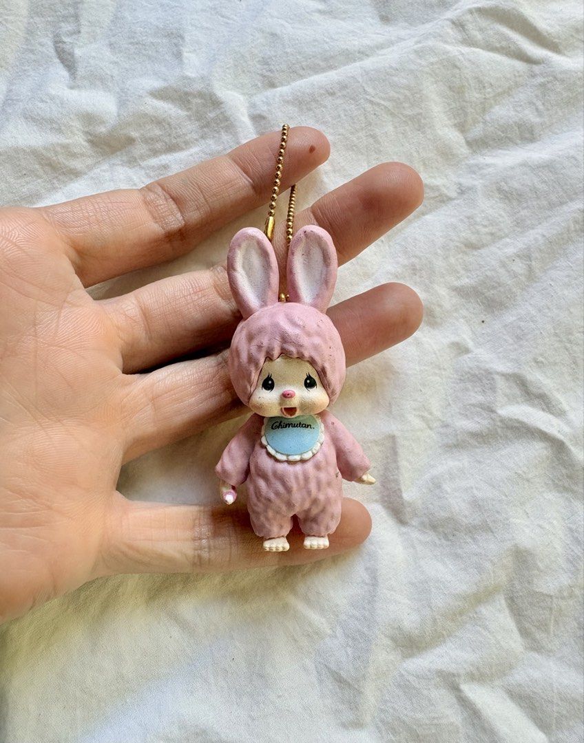 Sekiguchi Chimutan Pink Rabbit Doll Keychain (Category: Plushies & Soft Toys) located in Tuguegarao City. Submitted by jasminecoll (Listing ID 1465538308, Image 1). Description: - Authentic pink Sekiguchi Chimutan rabbit keychain - Features textured bunny suit, blue bib with Chimutan branding, and gold ball chain - Official Sekiguchi stamp on the back of the head - Compact size, ideal for bags, backpacks, or keys - Condition: Slight wear on extre