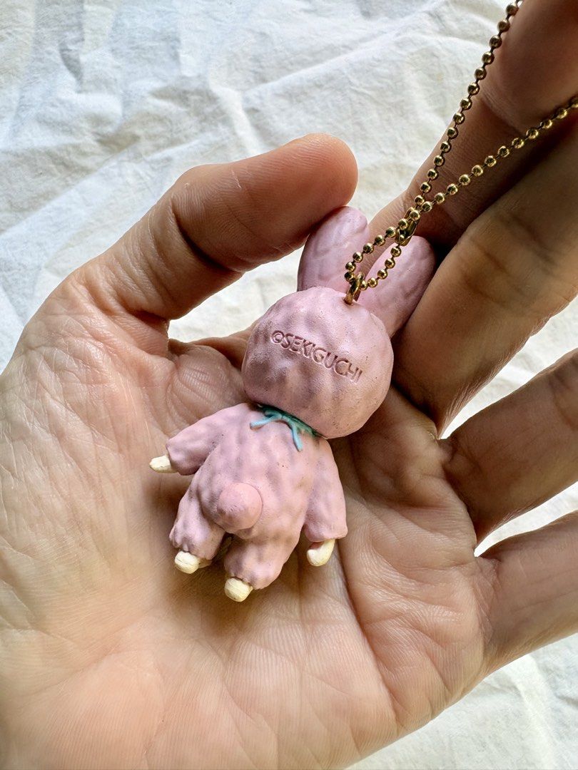 Sekiguchi Chimutan Pink Rabbit Doll Keychain (Category: Plushies & Soft Toys) located in Tuguegarao City. Submitted by jasminecoll (Listing ID 1465538308, Image 3). Description: - Authentic pink Sekiguchi Chimutan rabbit keychain - Features textured bunny suit, blue bib with Chimutan branding, and gold ball chain - Official Sekiguchi stamp on the back of the head - Compact size, ideal for bags, backpacks, or keys - Condition: Slight wear on extre