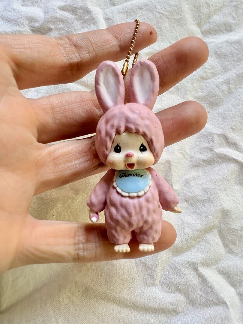 Sekiguchi Chimutan Pink Rabbit Doll Keychain (Category: Plushies & Soft Toys) located in Tuguegarao City. Submitted by jasminecoll (Listing ID 1465538308, Image 2). Description: - Authentic pink Sekiguchi Chimutan rabbit keychain - Features textured bunny suit, blue bib with Chimutan branding, and gold ball chain - Official Sekiguchi stamp on the back of the head - Compact size, ideal for bags, backpacks, or keys - Condition: Slight wear on extre