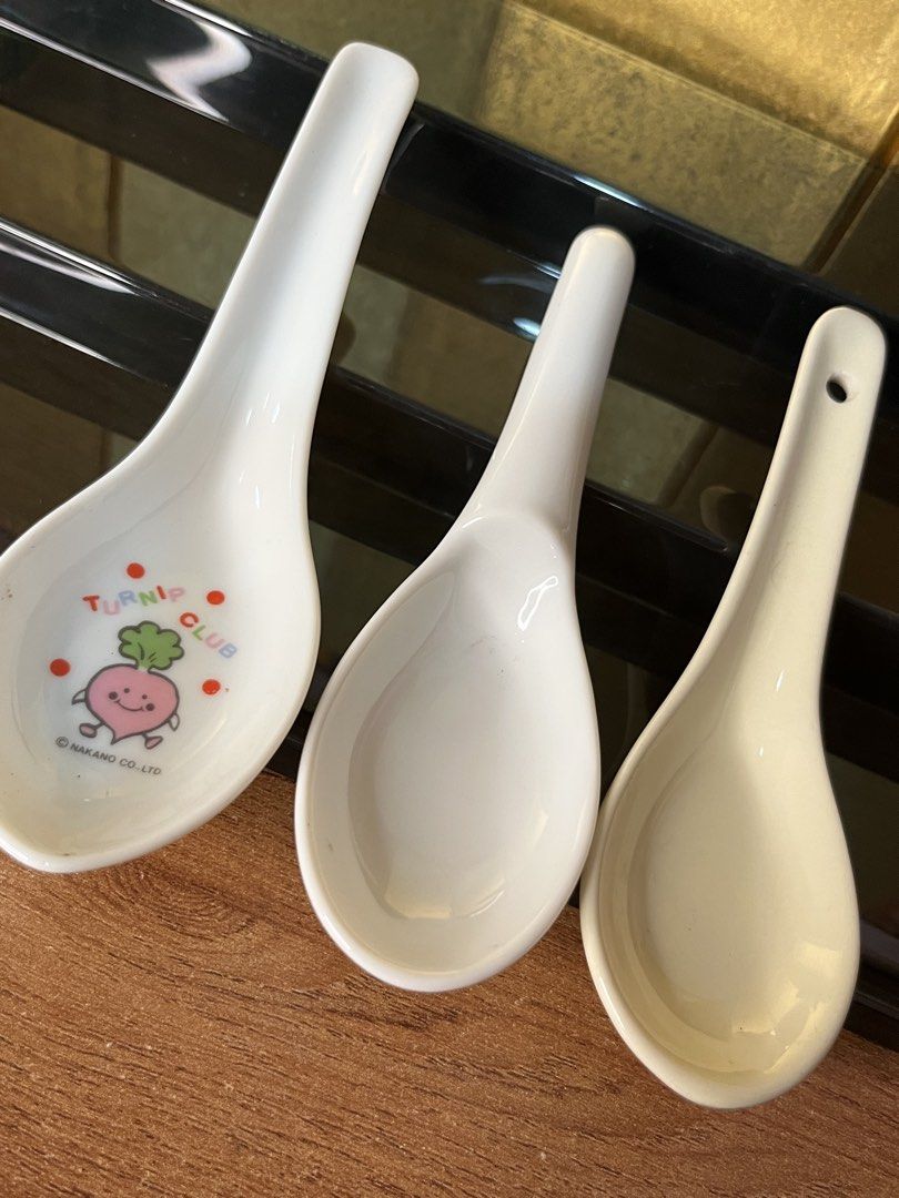 Set of 3 Ceramic Soup Spoons (Category: Dinnerware & Cutlery) located in Gapan. Submitted by lunashop14 (Listing ID 1465561550, Image 2). Description: - Set of 3 ceramic soup spoons for your kitchenware collection - Left spoon: Features a cute Turnip Club character graphic with Nakano Co. copyright - Middle spoon: Classic plain white design - Right spoon: Cream/off-white tint with a convenient hanging hole at the handle end - Condition: Like new 
