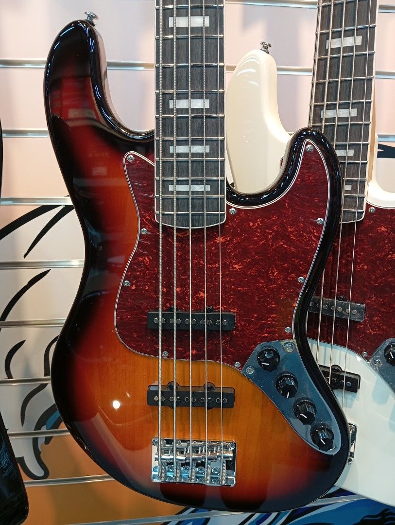 Severo 5-String Electric Bass Guitar (Category: Musical Instruments) located in Manila. Submitted by fabianpaolo93 (Listing ID 1465463867, Image 2). Description: - Model: Severo 5-string electric bass guitar - Finish: Glossy sunburst with a stylish tortoise shell pickguard - Pickups: Alnico active Dual single-coil pickups for a versatile, punchy tone - Fretboard: Features classic block inlays - Hardware: Premium chrome hardware - Condition: Brand