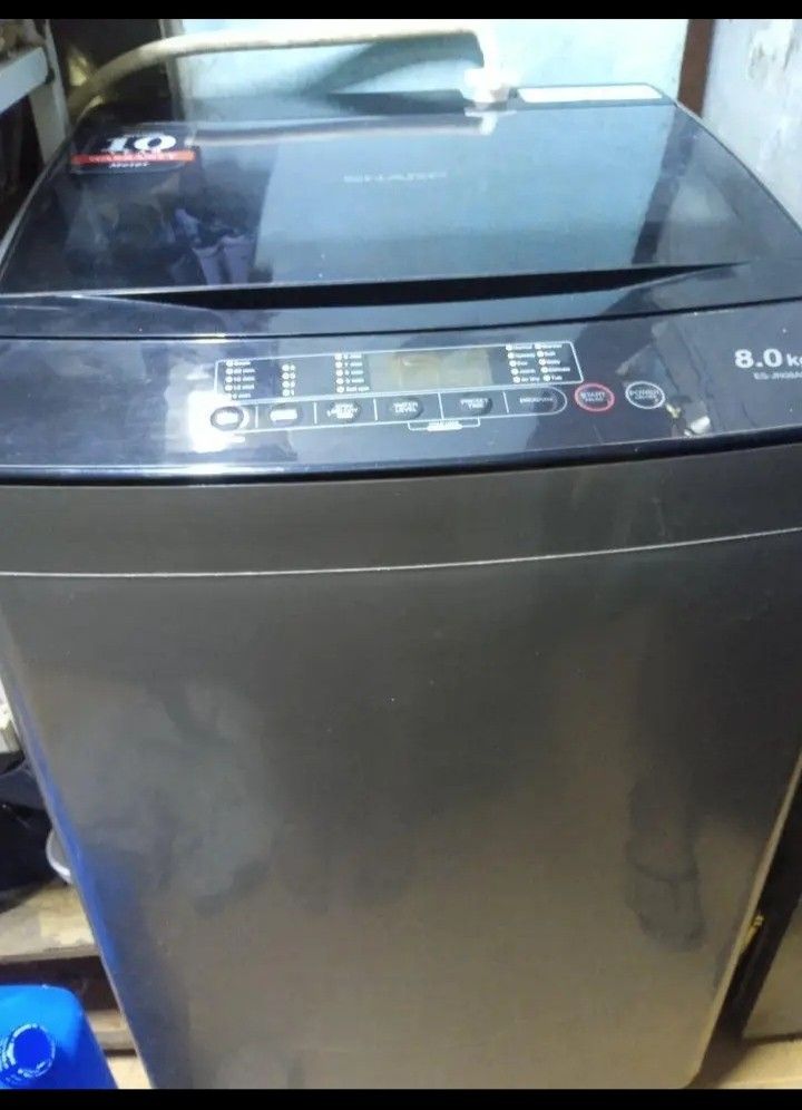Sharp 8.0kg Top Load Washing Machine ES-JN08A9 (Category: Washing Machines and Dryers) located in Manila. Submitted by dystuazon08573 (Listing ID 1465395048, Image 2). Description: - Brand/Model: Sharp ES-JN08A9 Top Load Washing Machine - Capacity: 8.0kg (ideal for daily laundry needs) - Color/Design: Dark grey finish with a sleek glass lid panel - Controls: Digital top control panel with multiple wash programs and water levels - Inclusions: Stan
