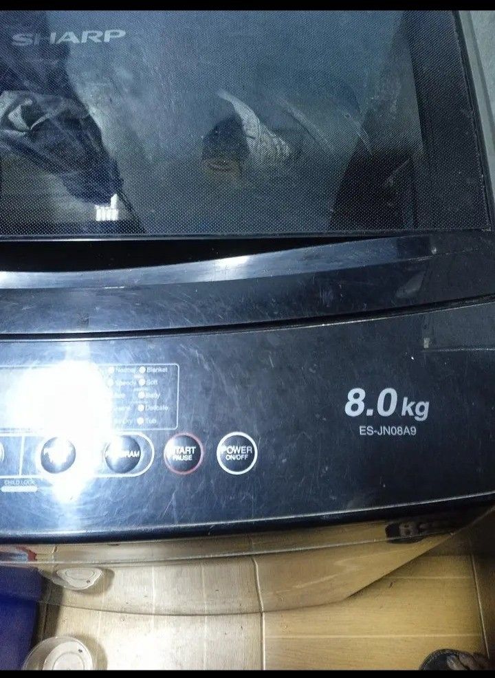 Sharp 8.0kg Top Load Washing Machine ES-JN08A9 (Category: Washing Machines and Dryers) located in Manila. Submitted by dystuazon08573 (Listing ID 1465395048, Image 1). Description: - Brand/Model: Sharp ES-JN08A9 Top Load Washing Machine - Capacity: 8.0kg (ideal for daily laundry needs) - Color/Design: Dark grey finish with a sleek glass lid panel - Controls: Digital top control panel with multiple wash programs and water levels - Inclusions: Stan