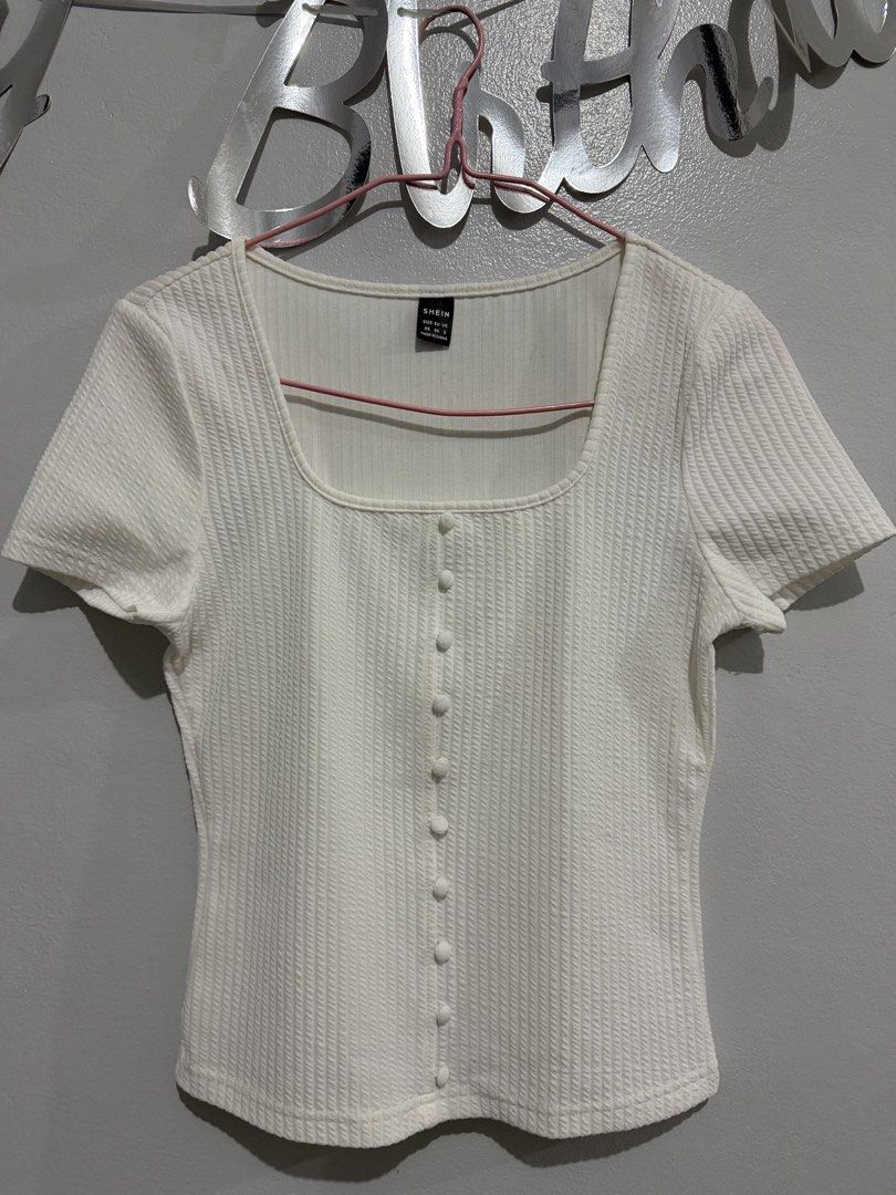 SHEIN White Ribbed Square Neck Button Top XS (Category: Sleeveless) located in Manila. Submitted by sheikbeep (Listing ID 1465493958, Image 2). Description: - Size: XS - Color: White - Style: Ribbed top with square neckline and short sleeves - Details: Decorative front button row, form-fitting cut, straight hem - Condition: Excellent, no flaws spotted.