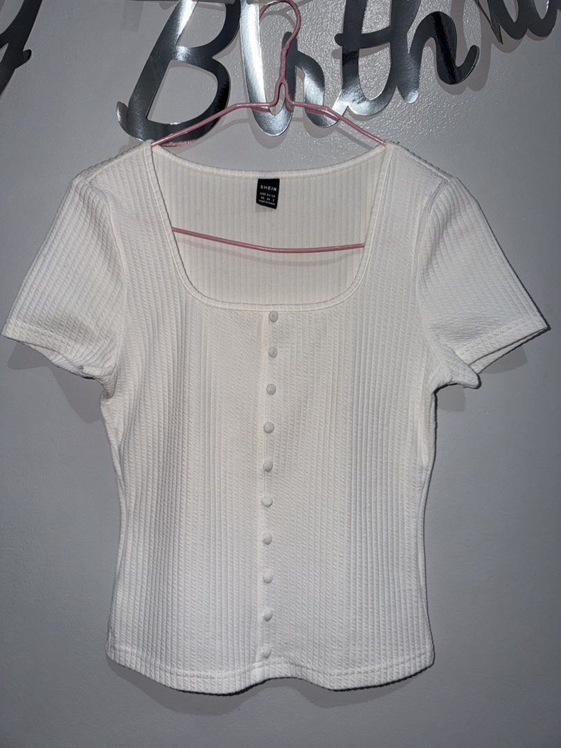 SHEIN White Ribbed Square Neck Button Top XS (Category: Sleeveless) located in Manila. Submitted by sheikbeep (Listing ID 1465493958, Image 1). Description: - Size: XS - Color: White - Style: Ribbed top with square neckline and short sleeves - Details: Decorative front button row, form-fitting cut, straight hem - Condition: Excellent, no flaws spotted.