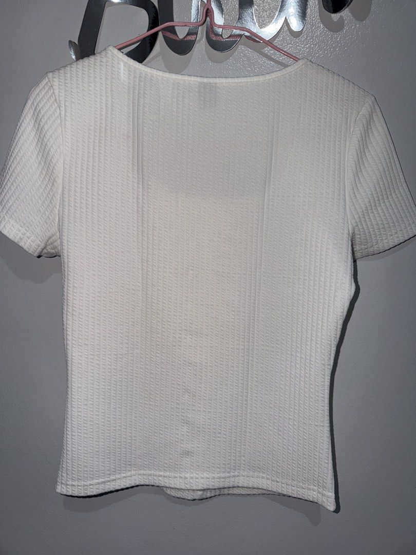 SHEIN White Ribbed Square Neck Button Top XS (Category: Sleeveless) located in Manila. Submitted by sheikbeep (Listing ID 1465493958, Image 3). Description: - Size: XS - Color: White - Style: Ribbed top with square neckline and short sleeves - Details: Decorative front button row, form-fitting cut, straight hem - Condition: Excellent, no flaws spotted.