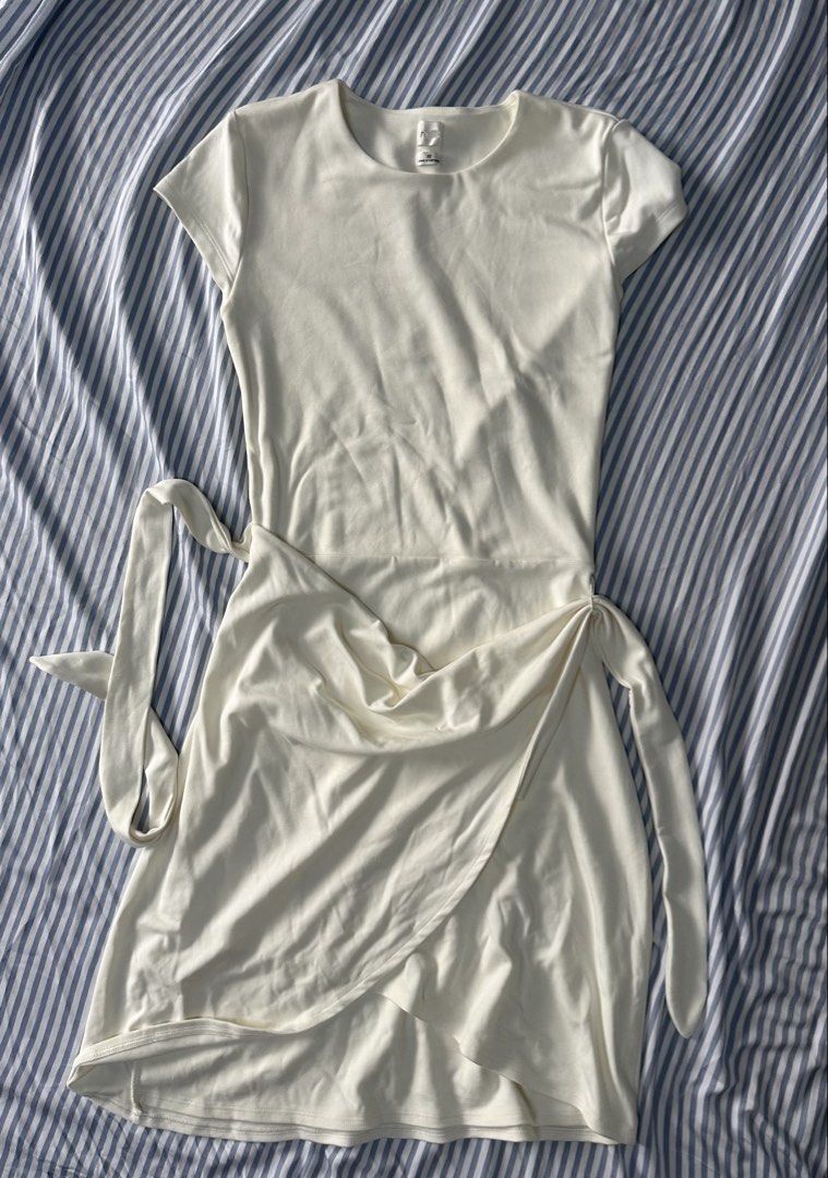 short-sleeve mini wrap dress with a side tie (Category: Dresses) located in Quezon City. Submitted by tan__k (Listing ID 1465397200, Image 3). Description: Size XS color light birch Brandnew A resort-wear essential, this is a mini wrap dress with short sleeves and a side tie. It’s made with Relux Jersey, an ultra-soft and drapey fabric that uses LENZING™ ECOVERO™ Viscose — responsibly sourced wood-based fibres produced through a process that redu