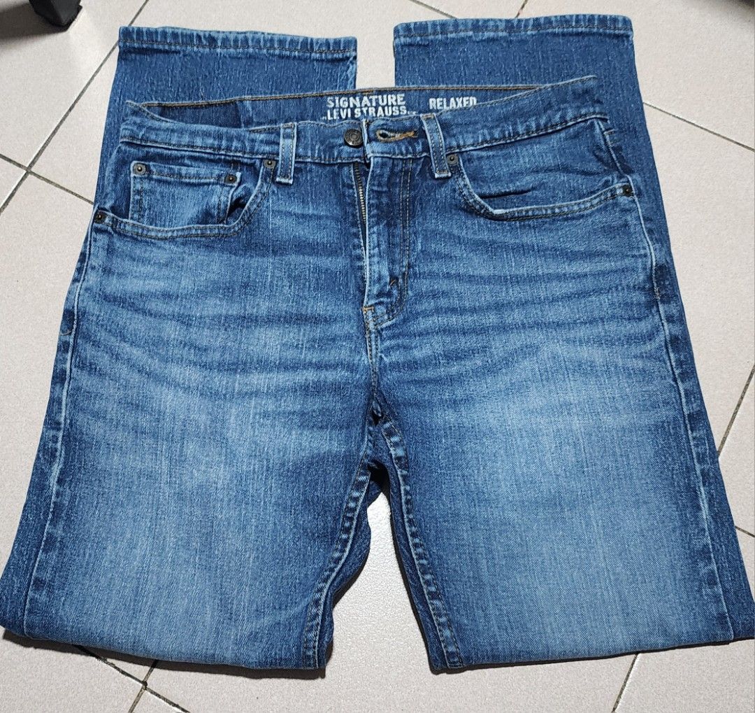 Signature Levi Strauss Relaxed Fit Jeans (Category: Jeans) located in Manila. Submitted by chichayako (Listing ID 1465450708, Image 1). Description: Signature Levi Strauss relaxed fit jeans in a medium blue wash. Classic five-pocket styling with standard button closure and zip fly. Leather patch on the back waistband. Material is a cotton blend with stretch. Straight legs, regular length. Interior care label lists machine wash instructions and fa