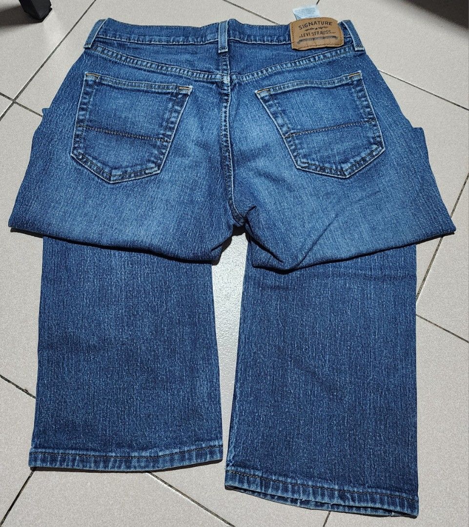 Signature Levi Strauss Relaxed Fit Jeans (Category: Jeans) located in Manila. Submitted by chichayako (Listing ID 1465450708, Image 2). Description: Signature Levi Strauss relaxed fit jeans in a medium blue wash. Classic five-pocket styling with standard button closure and zip fly. Leather patch on the back waistband. Material is a cotton blend with stretch. Straight legs, regular length. Interior care label lists machine wash instructions and fa