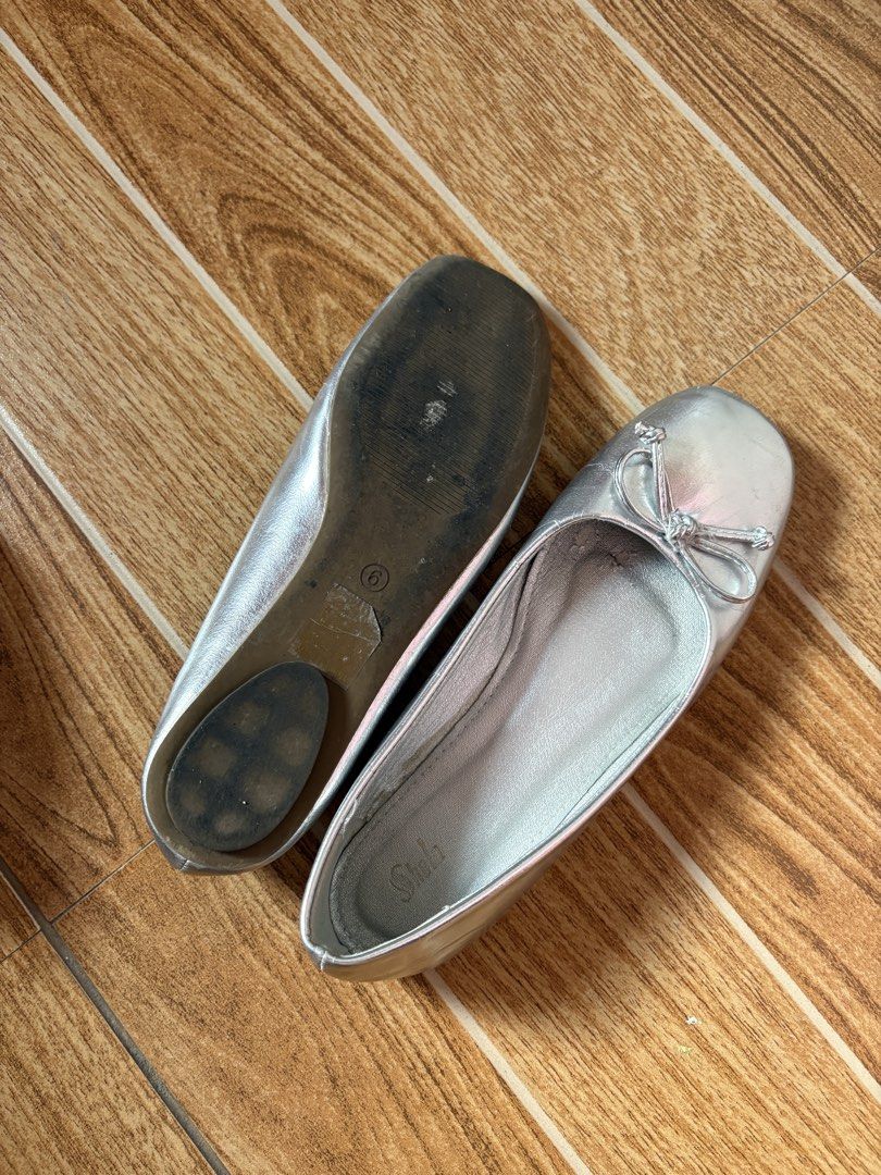Silver Ballet Flats with Bow Detail (Category: Flats & Sandals) located in Manila. Submitted by _foryou (Listing ID 1465406298, Image 2). Description: - Color/Design: Shiny silver with a cute bow on the toe - Size: 6 (stamped on sole) - Style: Easy slip-on flats - Condition: Clean insoles, normal scuffs on soles from walking, plenty of life left - Perfect for: Casual daily wear and effortless styling.