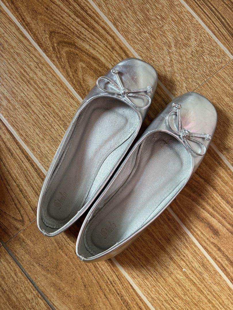 Silver Ballet Flats with Bow Detail (Category: Flats & Sandals) located in Manila. Submitted by _foryou (Listing ID 1465406298, Image 1). Description: - Color/Design: Shiny silver with a cute bow on the toe - Size: 6 (stamped on sole) - Style: Easy slip-on flats - Condition: Clean insoles, normal scuffs on soles from walking, plenty of life left - Perfect for: Casual daily wear and effortless styling.