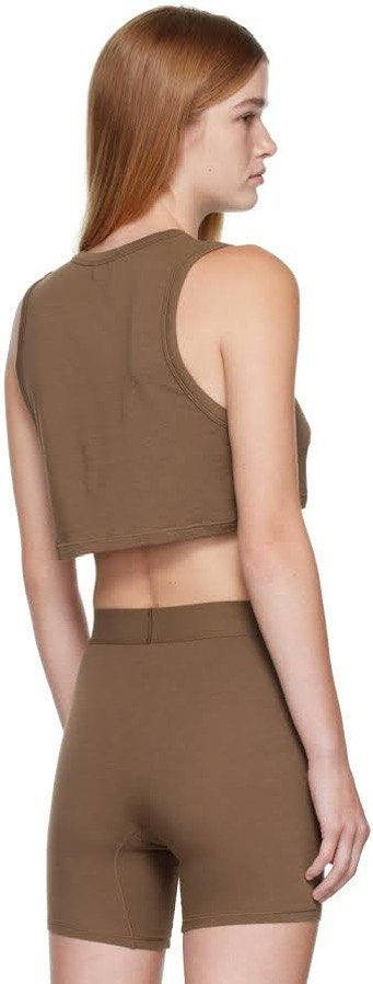 Skims Brown Crop Tank Top S (Category: Sleeveless) located in Rosales. Submitted by dariang22 (Listing ID 1465395851, Image 3). Description: - Color: Brown - Material: Soft, stretchy cotton -fit up to medium - Fit: Cropped tank top - Style: Simple, versatile basic for warm weather or layering - Condition: Worn a few times, washed and stored properly.