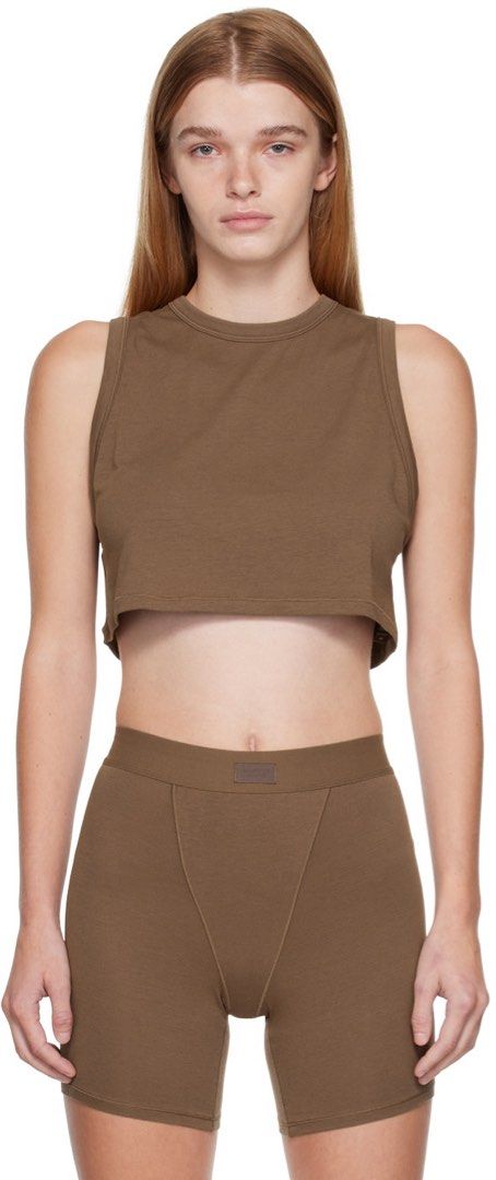 Skims Brown Crop Tank Top S (Category: Sleeveless) located in Rosales. Submitted by dariang22 (Listing ID 1465395851, Image 2). Description: - Color: Brown - Material: Soft, stretchy cotton -fit up to medium - Fit: Cropped tank top - Style: Simple, versatile basic for warm weather or layering - Condition: Worn a few times, washed and stored properly.