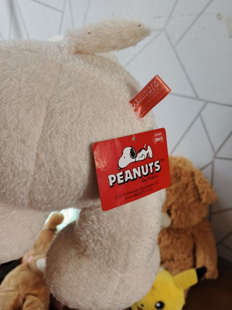 Snoopy Peanuts Stuffed Toy Plush (Category: Plushies & Soft Toys) located in Manila. Submitted by royalowl.cfe5f1 (Listing ID 1465417715, Image 3). Description: take all, orig branded from japan - Authentic 2013 Peanuts by Schulz Snoopy plush toy - Cream-colored body with classic black ears, round black nose, and big stitched paws - Made from super soft, fluffy material - Comes with original red paper tag and fabric tag attached - Perfect collect