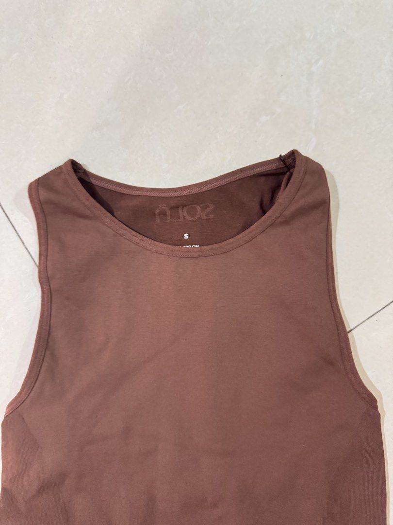 Sola body Hugging Brown Bodysuit (Category: Sleeveless) located in Quezon City. Submitted by sweetlyluxe (Listing ID 1465496546, Image 2). Description: - Brand: Sola Body Hugging collection - Color: Brown - Size: Small - Style: Crew neckline, sleeveless tank bodysuit - Material: Ribbed, stretchy fabric - Features: Bottom snap button closure, clean interior tags - Condition: Great pre-loved condition, used for photo only - Versatility: Perfect bas