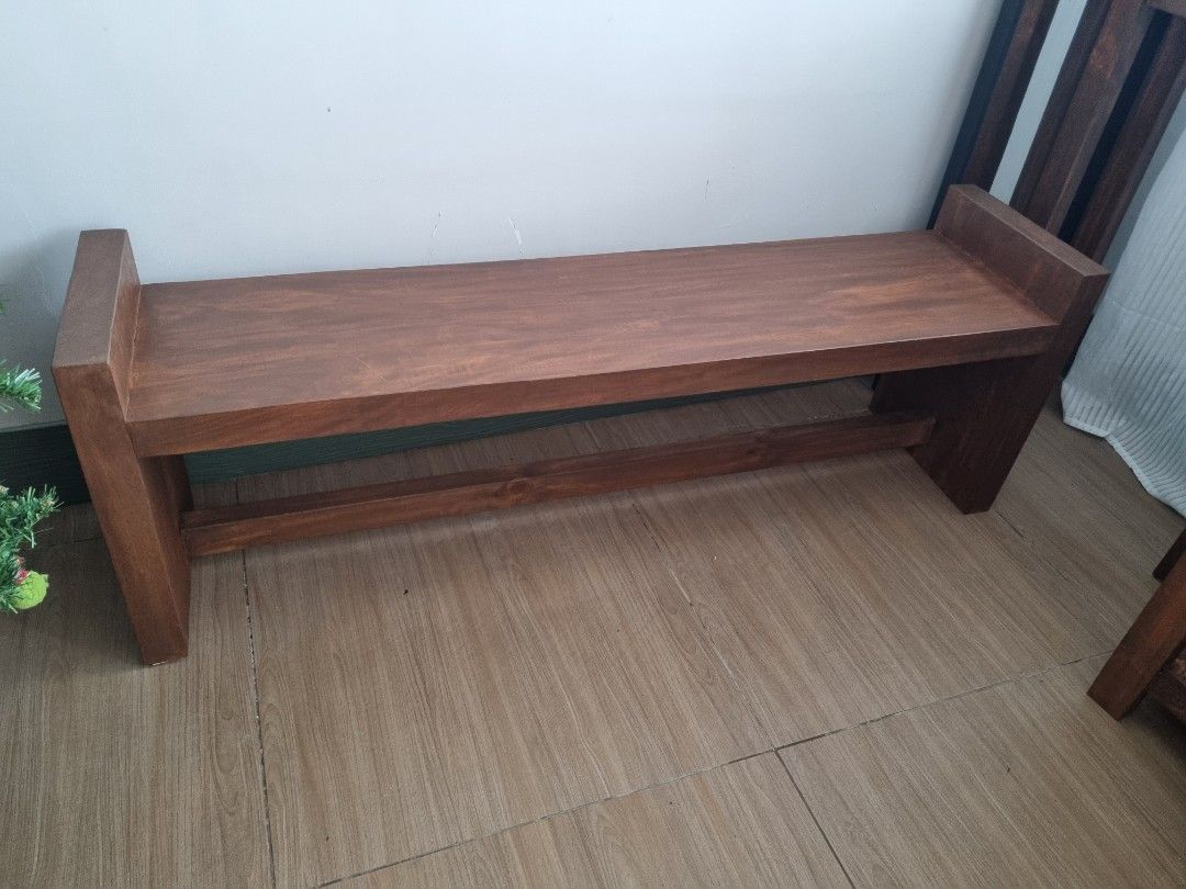 Solid Wood Bench with Custom Cushion (Category: Chairs) located in Quezon City. Submitted by rusticwood8 (Listing ID 1465399127, Image 2). Description: - Material: Solid dark wood with a deep rich stain - Cushion: Removable and washable beige upholstered cover - Design: Sturdy build with clean lines and lower support stretcher - Condition: Heavy, stable, and well-maintained - Versatility: Great for entryways, dining tables, or the foot of a bed.