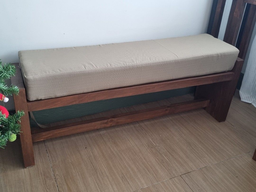 Solid Wood Bench with Custom Cushion (Category: Chairs) located in Quezon City. Submitted by rusticwood8 (Listing ID 1465399127, Image 1). Description: - Material: Solid dark wood with a deep rich stain - Cushion: Removable and washable beige upholstered cover - Design: Sturdy build with clean lines and lower support stretcher - Condition: Heavy, stable, and well-maintained - Versatility: Great for entryways, dining tables, or the foot of a bed.