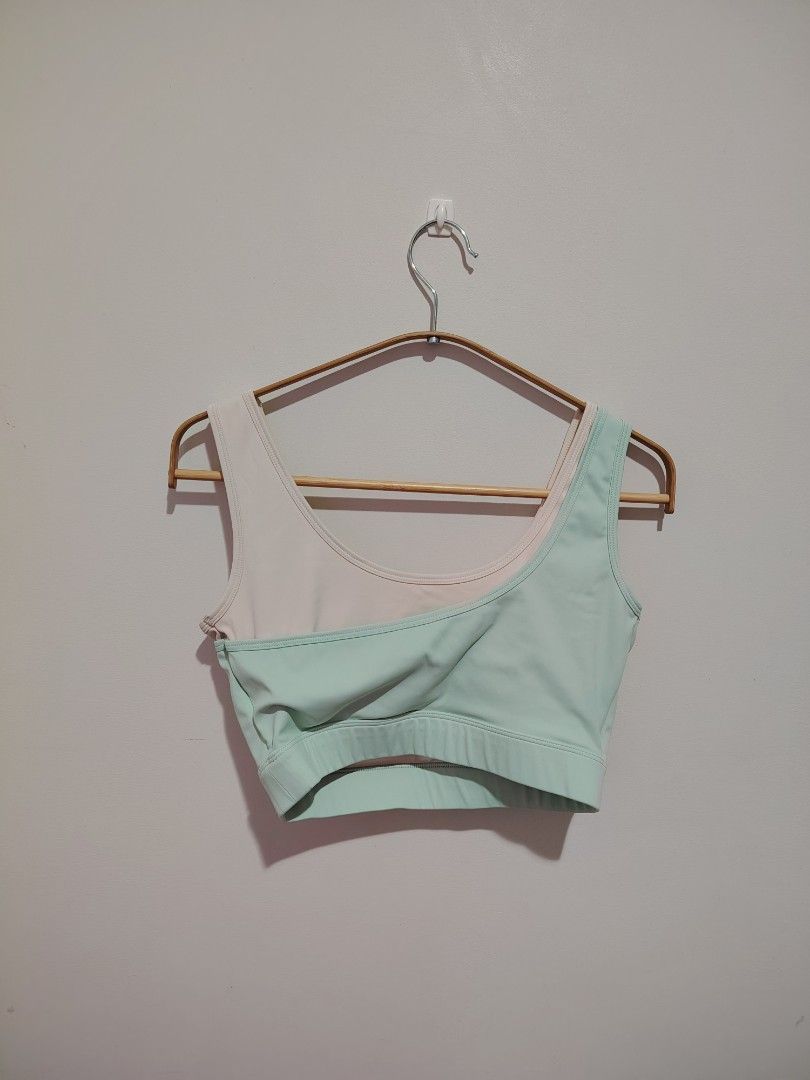 Sports Bra Mint Green (Category: Activewear) located in Mandaluyong City. Submitted by declutter_kween (Listing ID 1465526643, Image 3). Description: - Color: Pastel green and cream - Design: Asymmetric layered look with scoop neckline - Support: Wide underband and thick shoulder straps - Material: Stretchy athletic fabric - Best for: Workouts, yoga, and everyday athleisure wear - Size says XL but should fit M better.