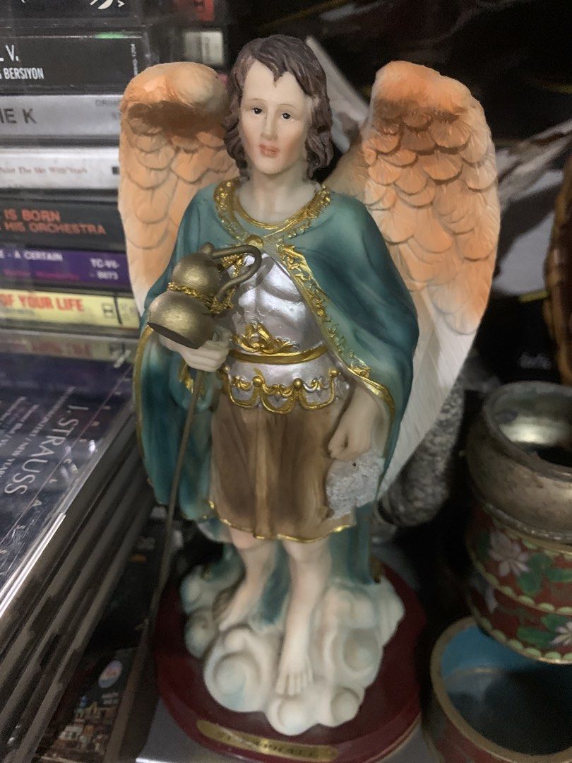 St. Raphael Archangel Resin Statue Figurine (Category: Figurines & Statues) located in Quezon City. Submitted by sojisup (Listing ID 1465489631, Image 3). Description: - Beautiful and detailed Saint Raphael the Archangel figurine - Features striking gold-tone armor, a teal cloak, and feathered wings - Holds his signature staff with a flask and a fish - Stands on a cloud base with a red platform and 'St. Raphael' name plate - Ideal for home altars